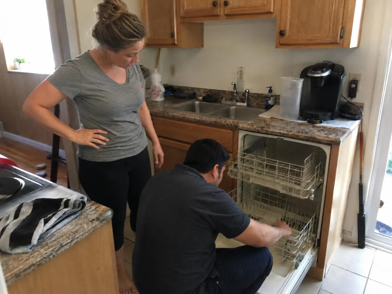 Technician completing an appliance repair in the kitchen