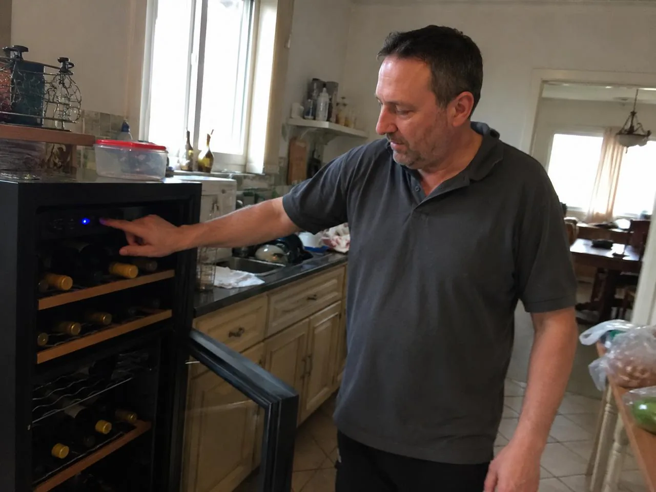 Technician checking a built-in wine cooler